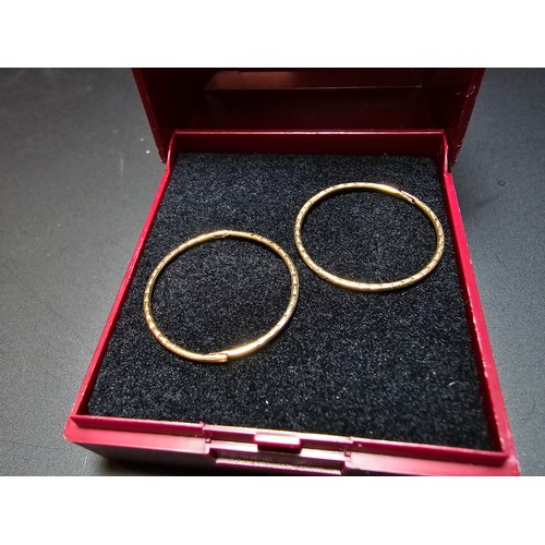 339 - Pair of 9ct. yellow gold hoop earrings in excellent clean condition boxed. Total weight 0.8g.