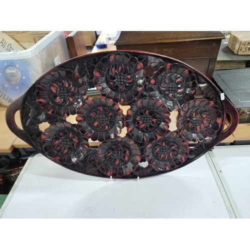 81 - 2x large oval rosewood Japanese drink serving trays with 9 inset floral cravings on each, both in go... 