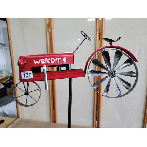 137 - A Welcome metal tractor garden stake with a rotational back wheel that turns in the wind in good ove... 