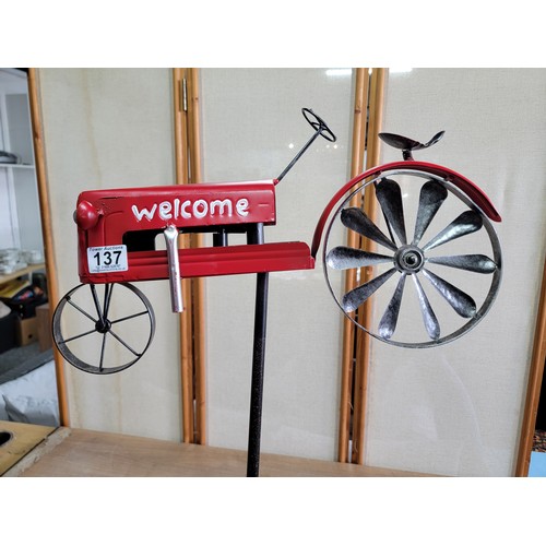 137 - A Welcome metal tractor garden stake with a rotational back wheel that turns in the wind in good ove... 