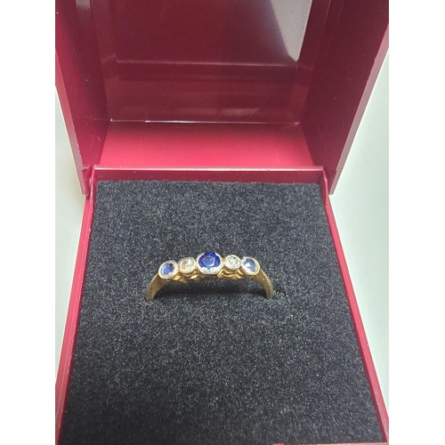 350 - An 18ct yellow gold 5 stone ring inset with 3 blue sapphire stones and 2 diamond stones in platinum ... 