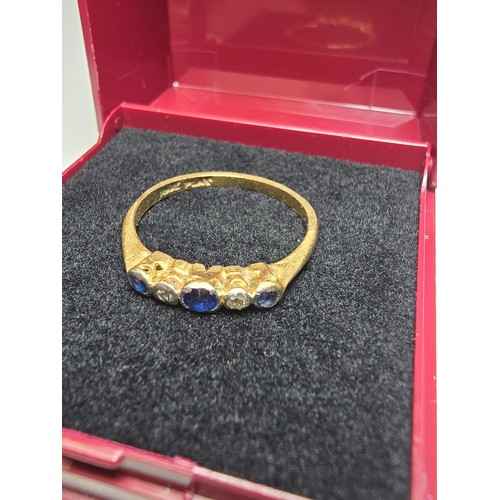 350 - An 18ct yellow gold 5 stone ring inset with 3 blue sapphire stones and 2 diamond stones in platinum ... 