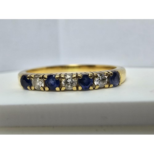 351 - A good quality hallmarked 18ct yellow gold 7 stone ring inset with 3 diamond stones and 4 sapphire s... 