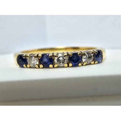 351 - A good quality hallmarked 18ct yellow gold 7 stone ring inset with 3 diamond stones and 4 sapphire s... 