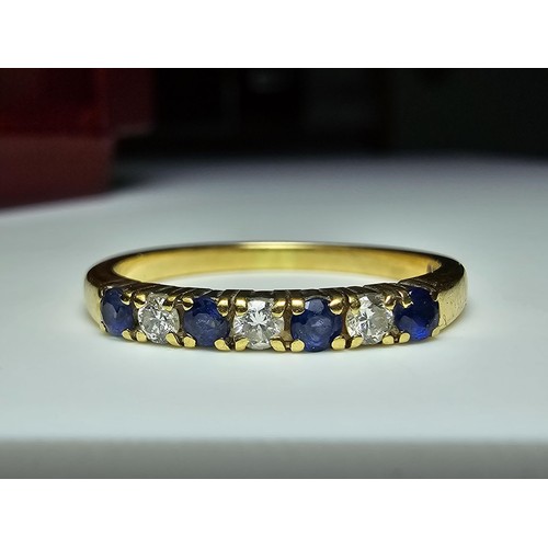 351 - A good quality hallmarked 18ct yellow gold 7 stone ring inset with 3 diamond stones and 4 sapphire s... 