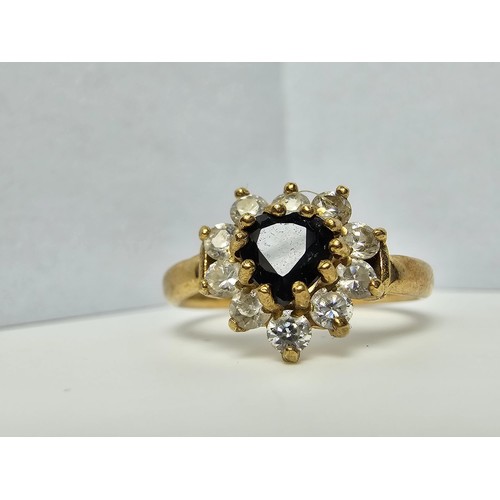 352 - A 9ct yellow gold cluster ring inset with a heart shaped black onyx stone to the centre surrounded b... 