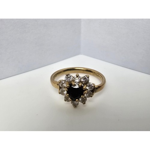 352 - A 9ct yellow gold cluster ring inset with a heart shaped black onyx stone to the centre surrounded b... 