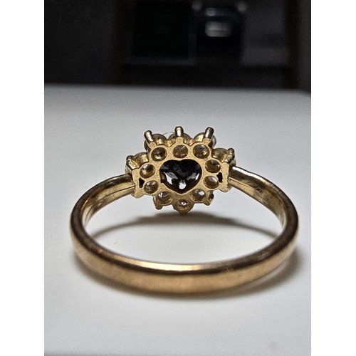 352 - A 9ct yellow gold cluster ring inset with a heart shaped black onyx stone to the centre surrounded b... 