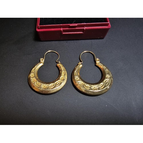 357 - A pair of large 9ct horseshoe shaped drop earrings with an engraved design in excellent clean condit... 