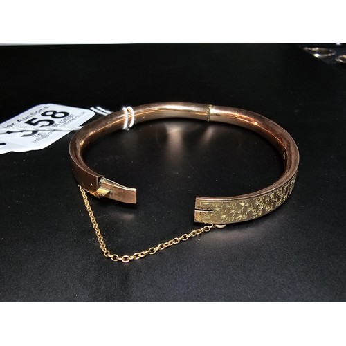 358 - A good quality vintage 9ct rose gold hinged bangle featuring an engraved design complete with its sa... 