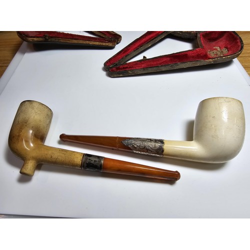 341 - 2x good quality vintage cased smoking pipes both having  hallmarked silver ferrules and solid amber ... 