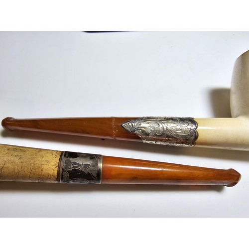 341 - 2x good quality vintage cased smoking pipes both having  hallmarked silver ferrules and solid amber ... 