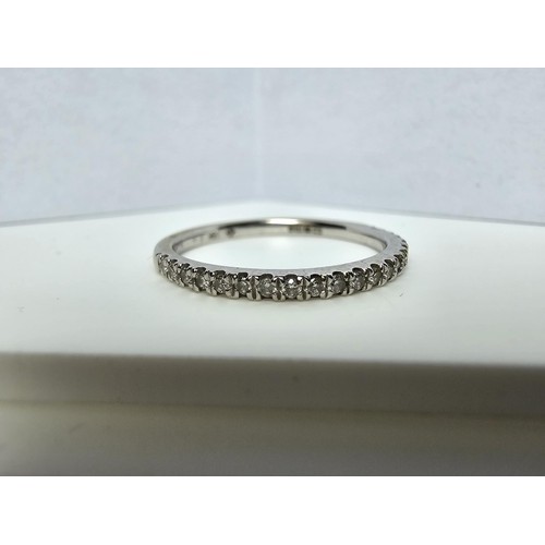 344 - An 18ct white gold half eternity ring inset with approx 20 diamonds with a combined weight of the di... 