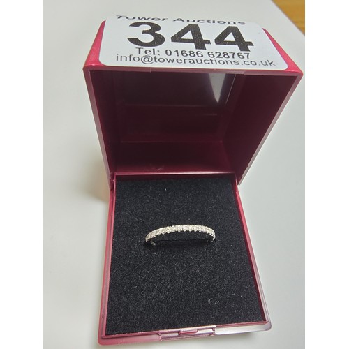 344 - An 18ct white gold half eternity ring inset with approx 20 diamonds with a combined weight of the di... 