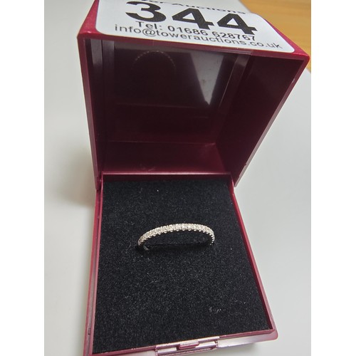 344 - An 18ct white gold half eternity ring inset with approx 20 diamonds with a combined weight of the di... 