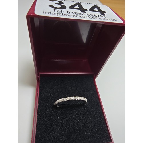 344 - An 18ct white gold half eternity ring inset with approx 20 diamonds with a combined weight of the di... 