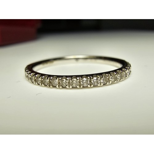 344 - An 18ct white gold half eternity ring inset with approx 20 diamonds with a combined weight of the di... 