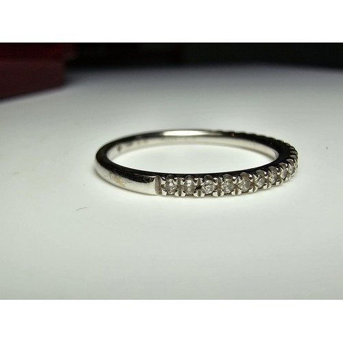 344 - An 18ct white gold half eternity ring inset with approx 20 diamonds with a combined weight of the di... 