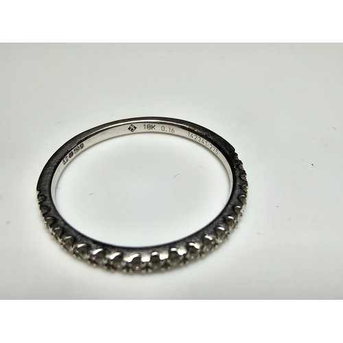 344 - An 18ct white gold half eternity ring inset with approx 20 diamonds with a combined weight of the di... 