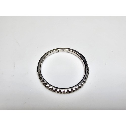 344 - An 18ct white gold half eternity ring inset with approx 20 diamonds with a combined weight of the di... 