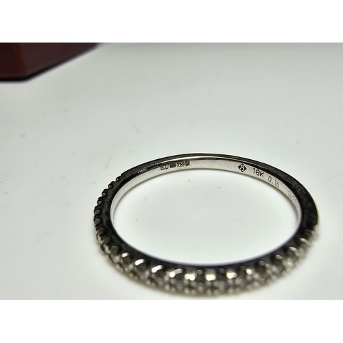 344 - An 18ct white gold half eternity ring inset with approx 20 diamonds with a combined weight of the di... 