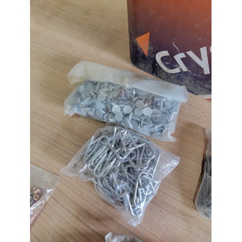 144 - Large tub containing a quantity of slate nails, screws, tacks, staples etc all in sealed bags