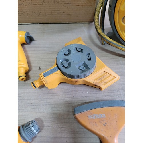 160 - Hozelock reel with hose along with a quantity of hozelock attachments inc a hozelock sprinkler