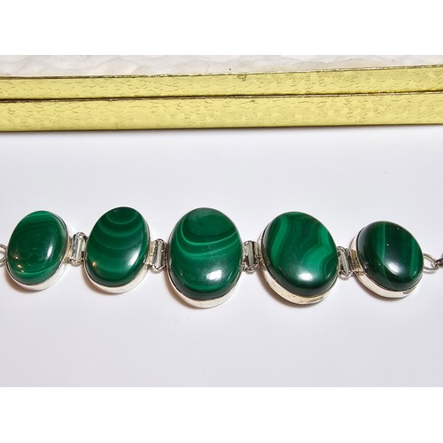 251 - A stunning 925 silver bracelet inset with large oval natural Malachite stones presenting an excellen... 