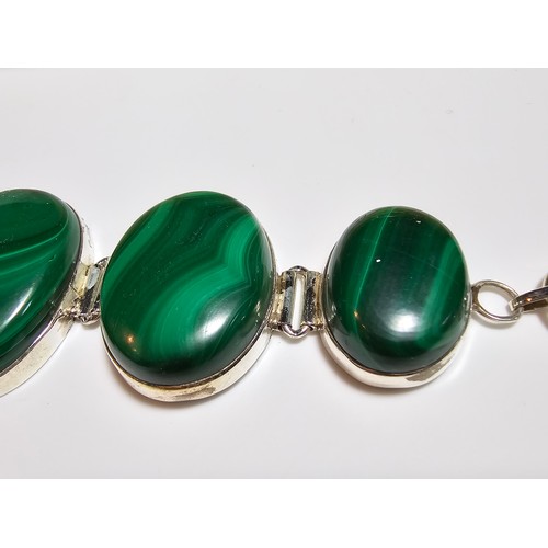 251 - A stunning 925 silver bracelet inset with large oval natural Malachite stones presenting an excellen... 