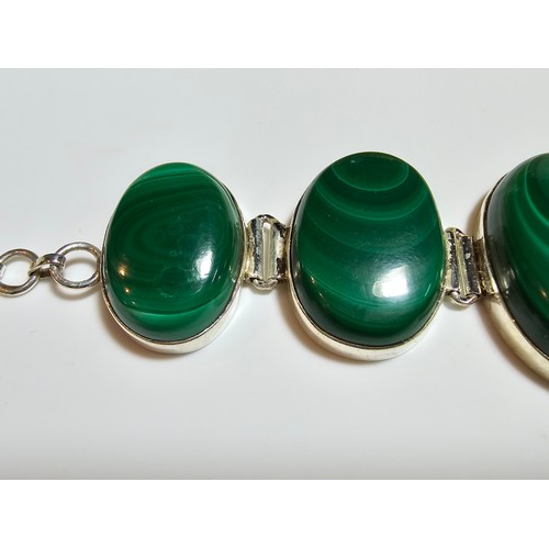 251 - A stunning 925 silver bracelet inset with large oval natural Malachite stones presenting an excellen... 