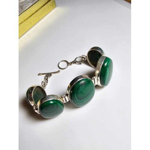 251 - A stunning 925 silver bracelet inset with large oval natural Malachite stones presenting an excellen... 