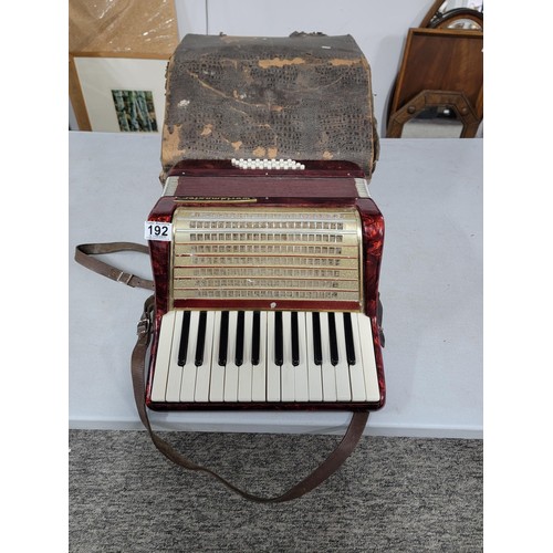 192 - Cased piano accordion by worldmaster, student model, bellows on the accordion are intact, some mould... 