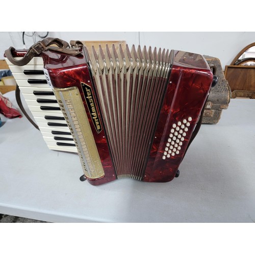 192 - Cased piano accordion by worldmaster, student model, bellows on the accordion are intact, some mould... 