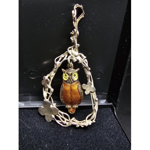 254 - An arts and crafts sterling silver pendant having an enamel gilt owl centre drop, in good clean cond... 