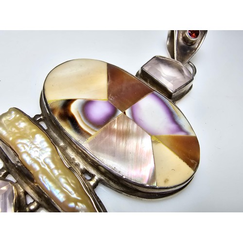 256 - A large and impressive 925 silver and multi gemstone statement pendant inset with mother of pearl an... 