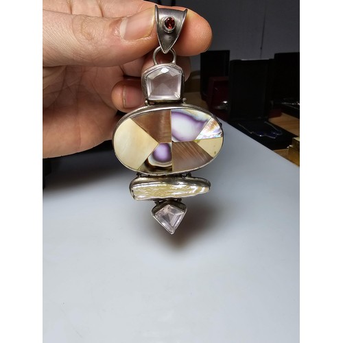 256 - A large and impressive 925 silver and multi gemstone statement pendant inset with mother of pearl an... 