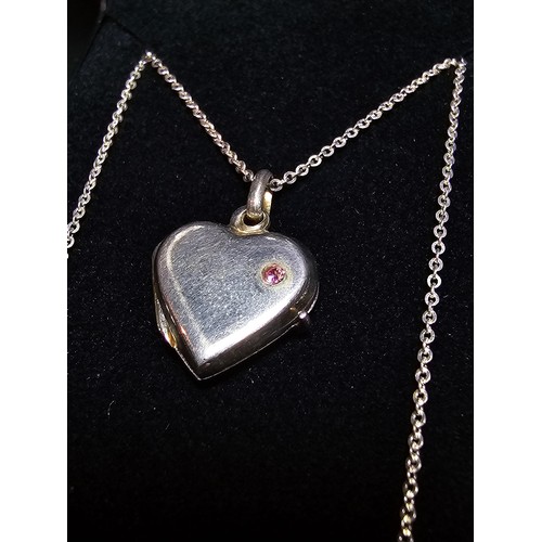 261 - A pretty 925 silver locket inset with a pink cz stone on a 16