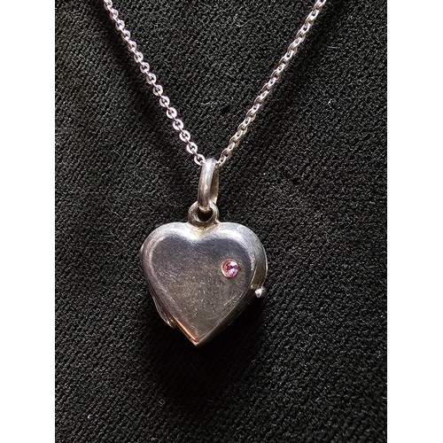 261 - A pretty 925 silver locket inset with a pink cz stone on a 16