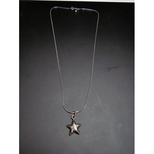 263 - A good quality 925 silver hand hammered star pendant set on a good quality long 22