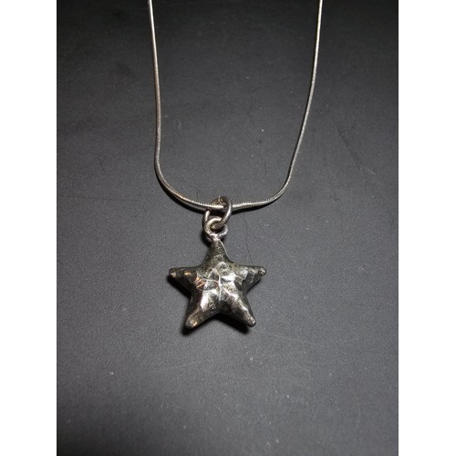 263 - A good quality 925 silver hand hammered star pendant set on a good quality long 22