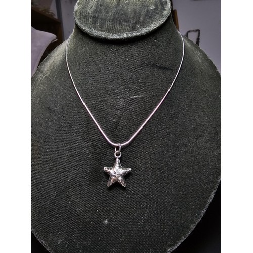 263 - A good quality 925 silver hand hammered star pendant set on a good quality long 22