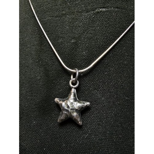 263 - A good quality 925 silver hand hammered star pendant set on a good quality long 22