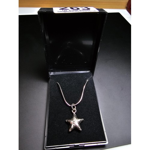 263 - A good quality 925 silver hand hammered star pendant set on a good quality long 22