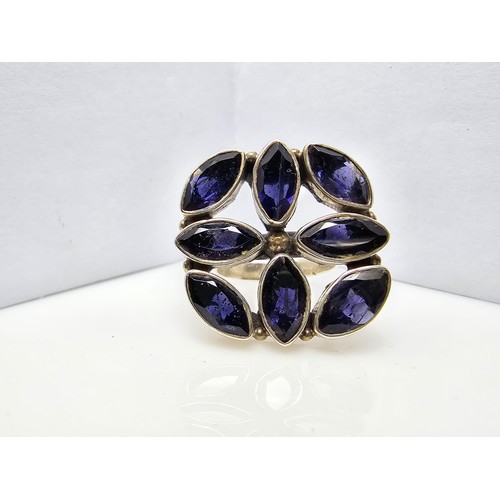 265 - A chunky 925 silver statement ring inset with 8x large faceted iolite gemstones presenting an excell... 