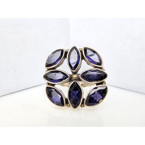 265 - A chunky 925 silver statement ring inset with 8x large faceted iolite gemstones presenting an excell... 