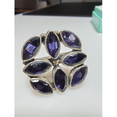 265 - A chunky 925 silver statement ring inset with 8x large faceted iolite gemstones presenting an excell... 