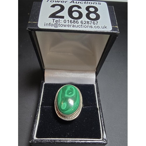 268 - A stunning 925 silver statement ring inset with a large oval malachite stone presenting an excellent... 