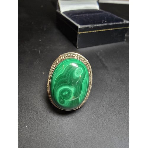 268 - A stunning 925 silver statement ring inset with a large oval malachite stone presenting an excellent... 