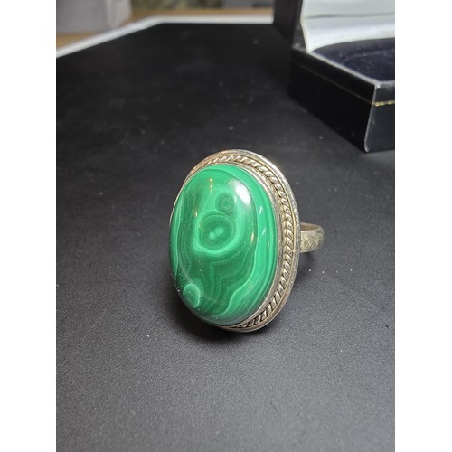 268 - A stunning 925 silver statement ring inset with a large oval malachite stone presenting an excellent... 