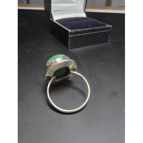 268 - A stunning 925 silver statement ring inset with a large oval malachite stone presenting an excellent... 